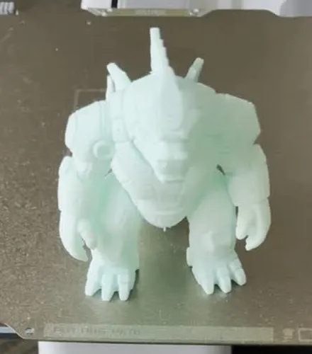 Mint green articulated robo-gorilla figure standing on the printer build plate
